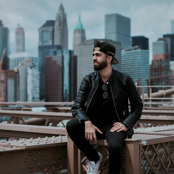 Young man in a leather jacket posing for a photoshoot